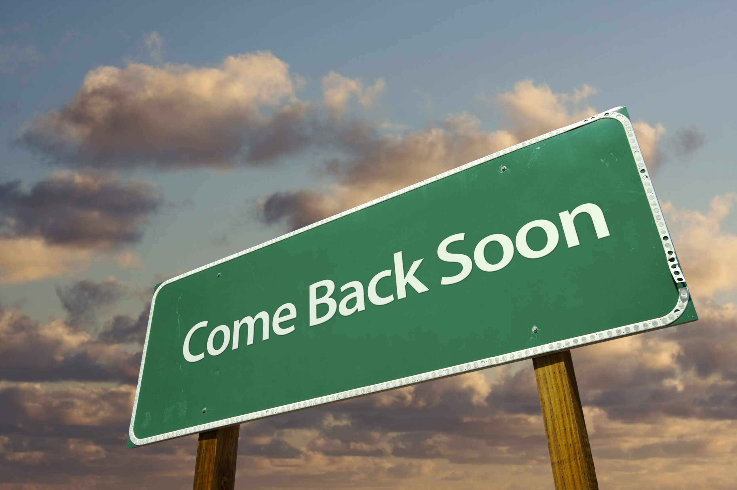 Come back soon inscription on a road sign